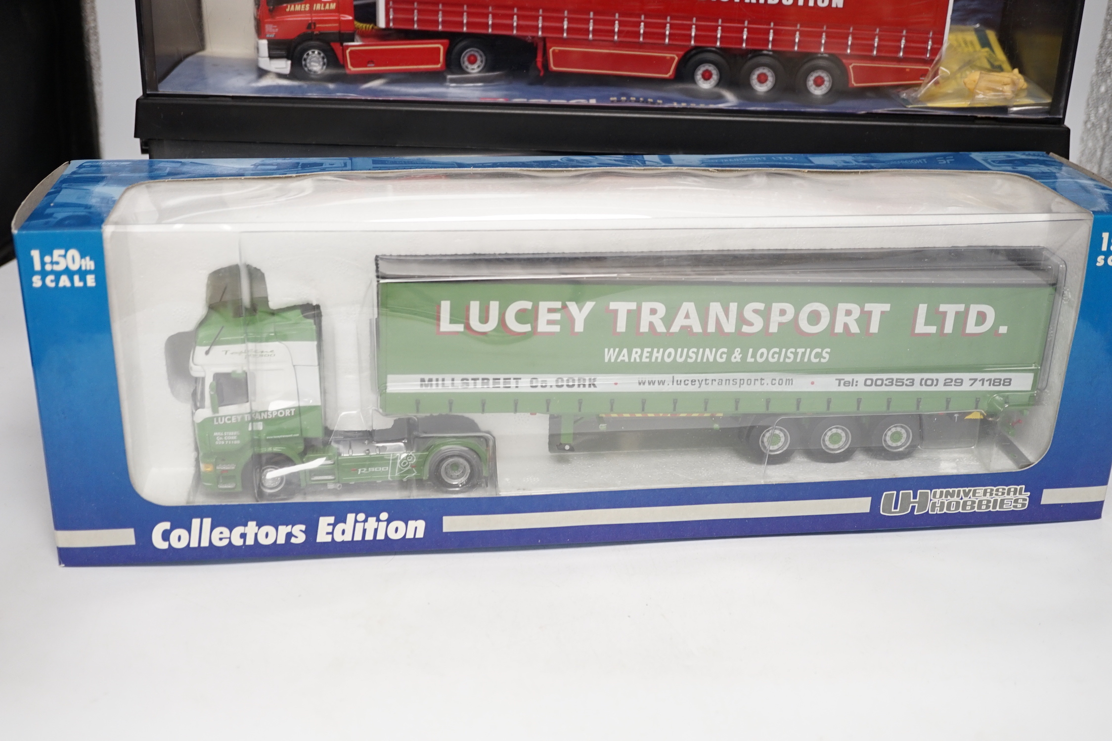 Four boxed Corgi and Universal Hobbies 1:50 scale articulated trucks; a Leyland DAF lorry (75401), an ERF curtainside lorry (75203), a Lion Toys DAF with box trailer, and a Universal Hobbies Scania Topline
